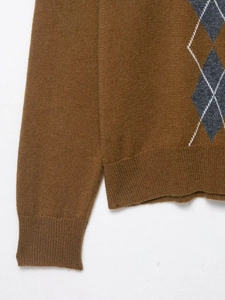 Close-up of the argyle knit pattern and ribbed cuffs on this dark brown men sweater
