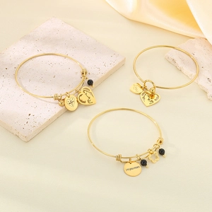 Golden heart-themed stainless steel bracelets set on silk background for Mother's Day gifts