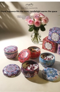 Macro shot of soy wax candles with dried flowers in mandala tins and gift boxes