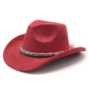 Red suede western cowboy hat with ethnic beaded band and wide brim on white background