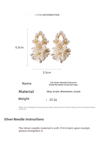 Detail view showing white flower earrings with butterfly and waterdrop crystal pendants