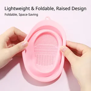 Collapsible pink silicone makeup brush cleaning bowl with textured scrubbing surface