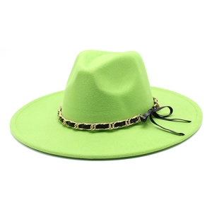 Close-up of lime green wool fedora with gold chain and black ribbon bow detail