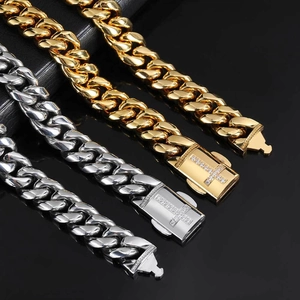 Polished gold and silver Cuban link chains with crystal-set cross buckles on dark background