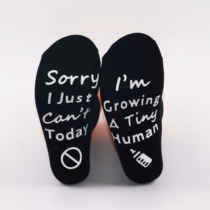Funny 'Growing A Tiny Human' non-slip maternity socks in black with white lettering
