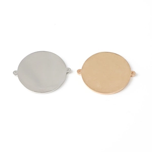 Close-up of gold and silver mirror-polished stainless steel round pendants with dual loops