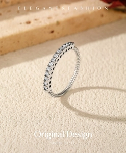 Macro shot of S925 sterling silver ring featuring sparkling pavé crystals and textured band