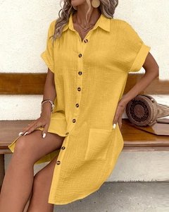 Detail of yellow cotton linen V-neck button dress with pocket and summer accessories