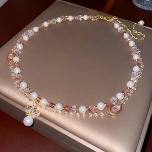Elegant double-layered necklace with zircon crown pendant, pearls, and pink crystals
