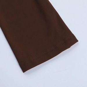 Close-up of dark brown knit fabric showing reinforced double-needle stitching and texture
