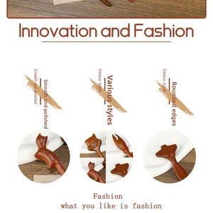Detailed view of polished sandalwood hairpins with smooth edges and cat and lobster shapes