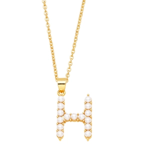 Close-up of gold chain necklace with H letter pendant inlaid with small white pearls
