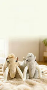 Detail view of plush mammoth toy showing soft grey and brown long-hair faux fur texture