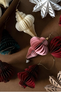 Macro view of origami paper Christmas ornaments with accordion folds and gold glitter edges