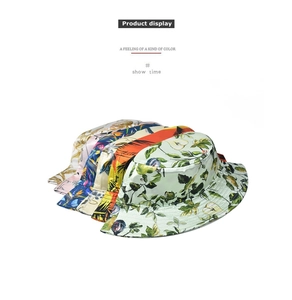 Detail showing various tropical floral and leaf patterns on cotton bucket hats for women