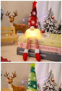 Close-up of glowing faceless Christmas gnome with knitted hat on festive book scene