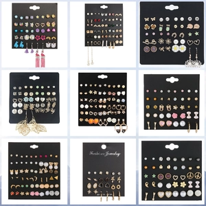 9-pair earring set featuring pearls, hearts, and geometric shapes on black display cards