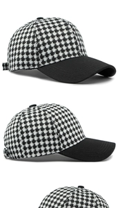 Detail showing contrast houndstooth pattern and black brim on adjustable baseball cap