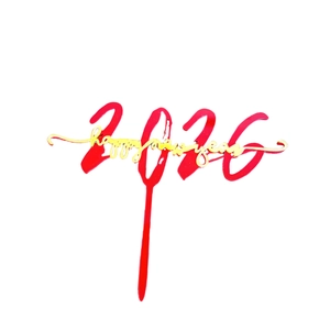 Detail of red 2026 and gold Happy New Year acrylic cake topper for party decoration