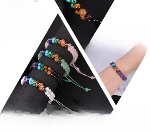 Macro detail of double-layer woven chakra natural stone bracelet with adjustable cord
