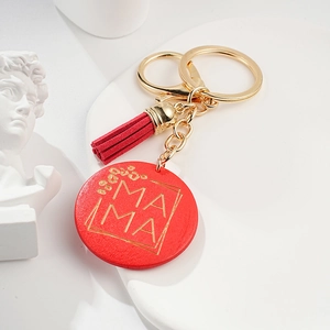Detailed view of red round Mother's Day keychain with gold MAMA text and stylish tassel
