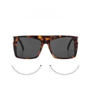 Detail of tortoise shell sunglasses frame with silver metal accents and gray lenses