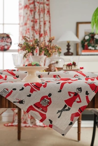 Detailed texture of cotton linen Christmas tablecloth with festive Santa Clause prints