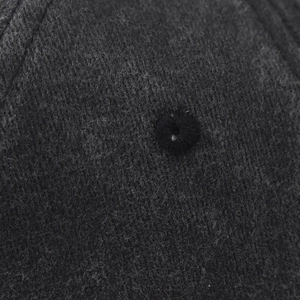 Detailed macro shot of the washed vintage fabric texture and stitching on the baseball cap