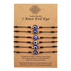 Detail of 6-piece woven lucky evil eye bracelets on kraft card packaging with description