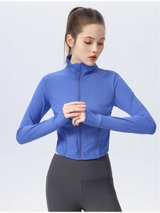 Detail of royal blue yoga jacket featuring thumbhole cuffs and ribbed fabric texture