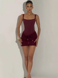 Detail of burgundy corset mini dress with sequined skirt and boning structure