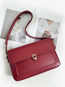 Vintage bordeaux red leather shoulder bag with gold metal buckle and sleek flap closure