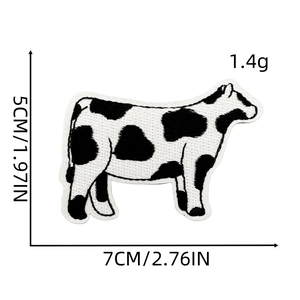 Embroidered black and white cow patch with 7cm width and 5cm height dimensions