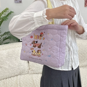 Quilted purple tote bag with cartoon dog embroidery and yellow handles on model