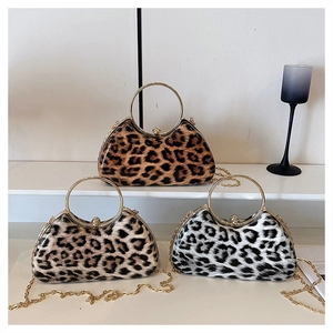Close-up of three leopard print evening clutch bags with gold metal ring handles and chains