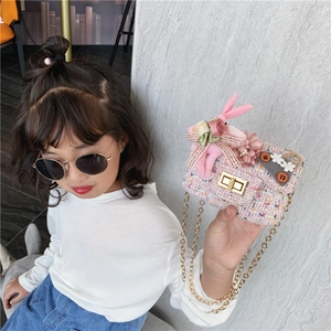 Pink tweed mini crossbody bag for girls featuring cute bunny doll and floral charms