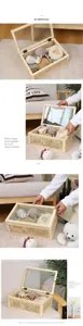 Detailed view of handmade woven storage box with a clear glass lid and inner dividers