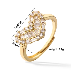 Close-up of gold heart ring with baguette zircons and adjustable open band