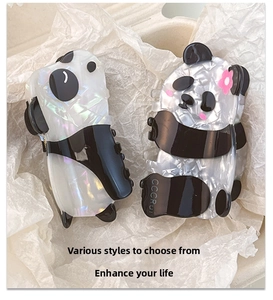 Detail of panda hair clips made of iridescent acetate with black and white finish