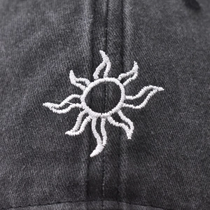 Washed cotton baseball cap in dark grey with white sun embroidery in a minimalist style