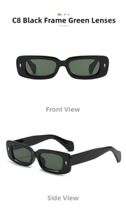 Detail view of rectangular black frames with green lenses and gold rivet accents