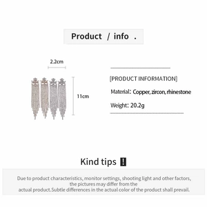 Detailed specs of long geometric tassel earrings with zircon stones and silver finish