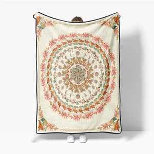Detail of soft flannel throw blanket featuring vintage mandala and moon phase patterns