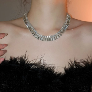 Close-up of luxury silver necklace with radiant rectangular crystals on a model