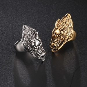 Retro dragon head rings in silver and gold finishes with detailed embossed scales
