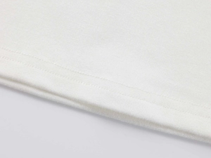 Macro shot of double-needle stitching on white modal fabric hem for sport T-shirts