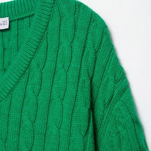 Green cable-knit V-neck sweater for women with thick wool texture and loose casual fit