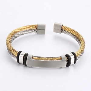 Industrial two-tone twisted cable open bangle featuring a brushed metal bar and rubber rings