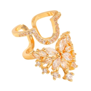 Detail of copper butterfly nail ring with cubic zirconia inlay on a wave-shaped band