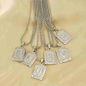 Classic silver square titanium steel initial necklaces on gold silk background